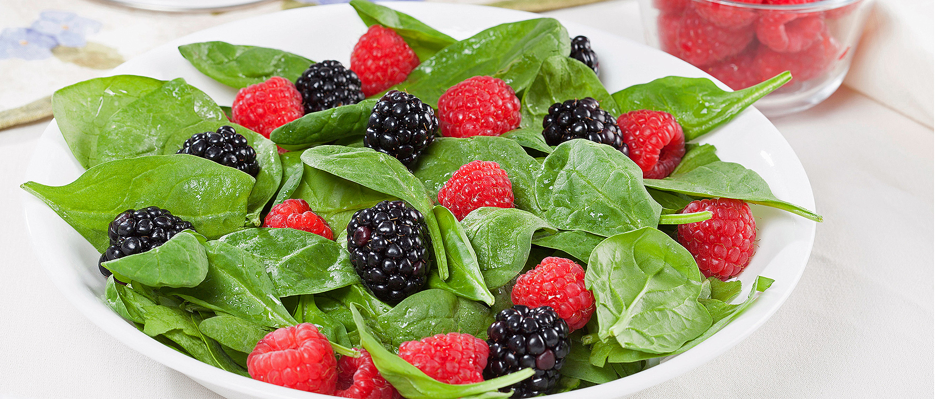 A spinach, raspberry and blackberry salad.