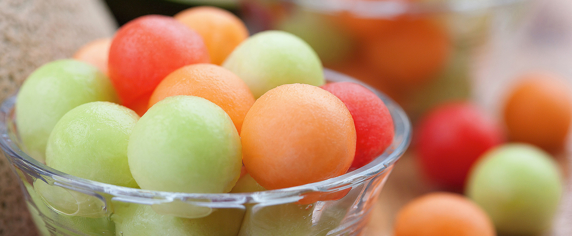 A bowl of honeydew, cantaloupe and watermelon balls. 