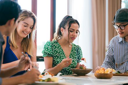 Two women and two men eating in a restaurant. 