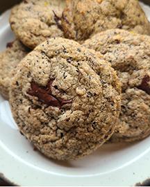 A plate of 5 chocolate chunk cookies.