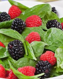 A spinach, raspberry and blackberry salad.