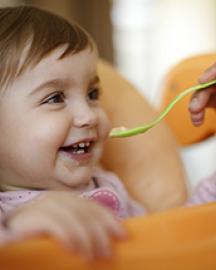 A baby being spoon fed
