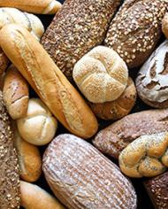 Many mixed breads and rolls shot from above.