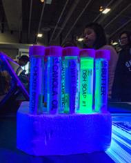 Test tubes viewed under a blacklight