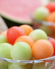 A bowl of honeydew, cantaloupe and watermelon balls. 