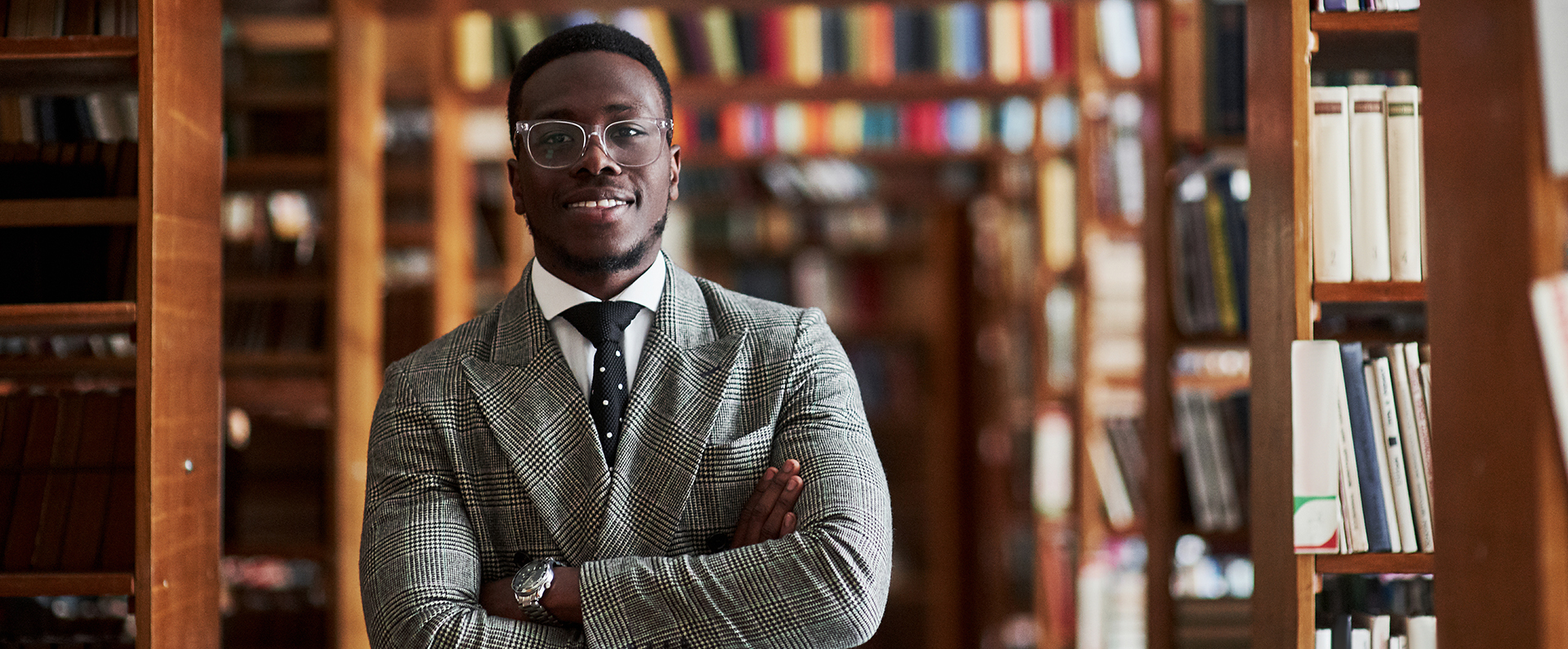 A man standing in front of a bookcase with his arms crossed with the words "Fuel Your Curiosity". Links to the Fuel Your Curiosity page where you can learn about ARS research. 