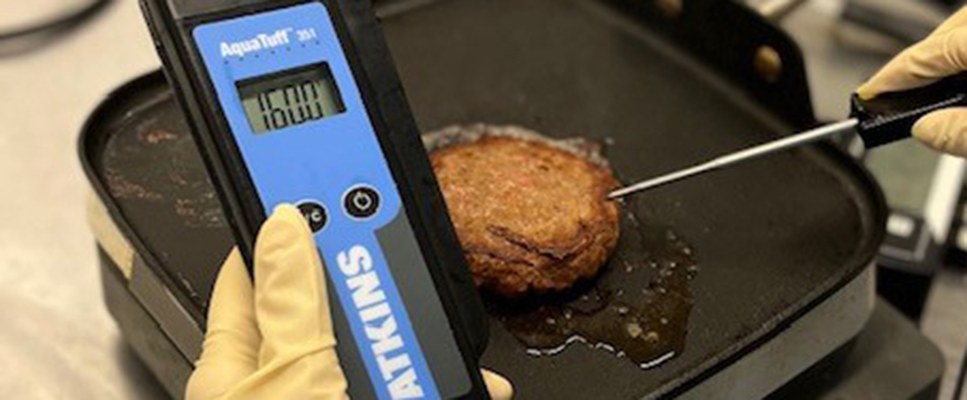 A thermometer checking the temperature of a plant burger